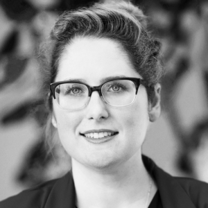 a headshot of Naomi Kasa - a woman with glasses and an updo